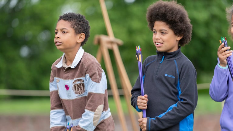 Children trying archery at the Medieval Festival at Tattershall Castle, Lincolnshire
